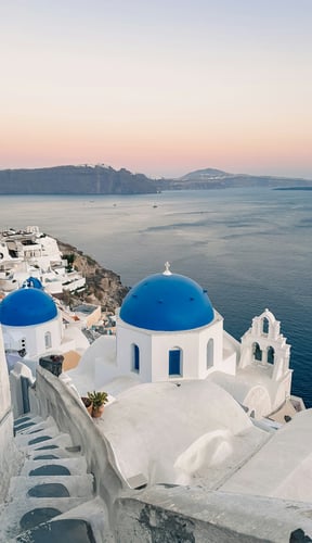 Santorini blue domes at sunset over the caldera, Greece