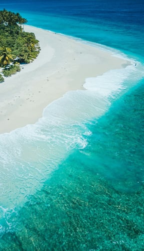 Aerial of white sand spit curving into turquoise Caribbean water